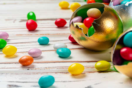 Easter concept. Eggs and colored sweets on table close up