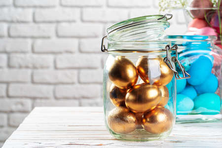 Glass jar with bright colored eggs for Easter celebration