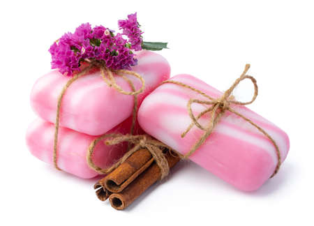 Pink bars of handmade natural soap and flowers isolated on whiteの写真素材