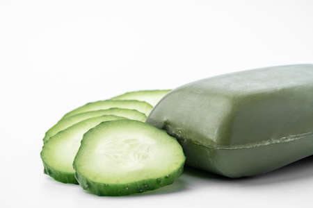 Soap bar with cucumber slices on white background.の写真素材