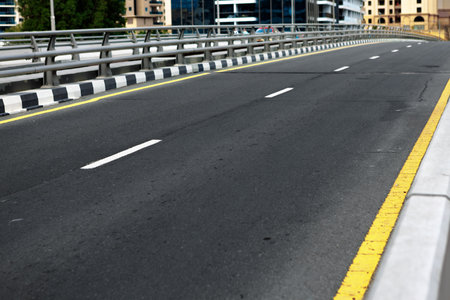 Asphalt road with modern city skyline of Dubai.