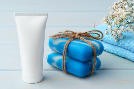 Soap and toiletries on shelf in blue bathroomの写真素材