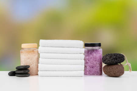 Various spa beauty threatment products and towels against blurred backgroundの写真素材