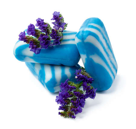 Bars of handmade natural soap and flowers on white backgroundの写真素材