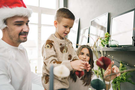 Happy family making Christmas decorations at home togetherの写真素材
