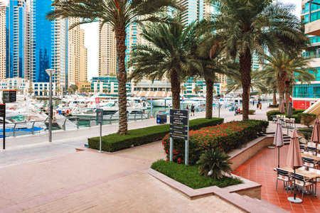DUBAI, UAE - MARCH 15, 2021: The promenade of Dubai Marina with the yachtsのeditorial素材