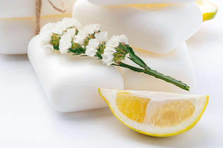 Handmade soap bars and lemon on white background.の写真素材