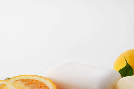Handmade citrus soap and fresh fruit on white background