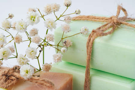 Soap bars with flowers on white surfaceの写真素材