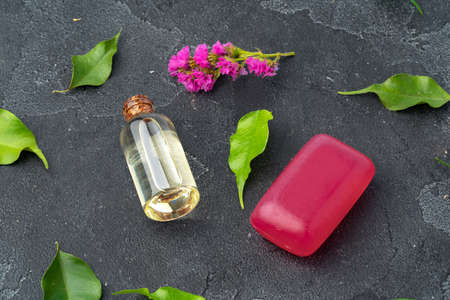 Skincare organic soap bars with plants extracts on gray surface.