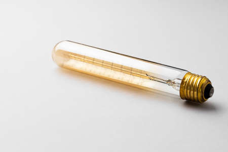Light bulb on light grey paper background