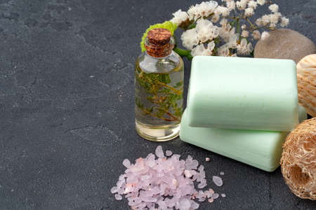 Skincare organic soap bars with plants extracts on gray surface.
