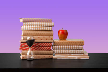 Stack of books on black wooden table
