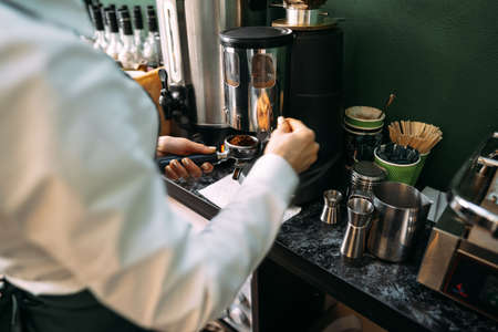 Close up of barista hands preparing coffee for customer in coffee shopの写真素材