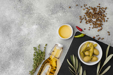 Olives and spices on a gray stone backgroundの写真素材