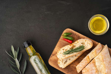 Italian ciabatta bread with olive oil on wooden backgroundの写真素材