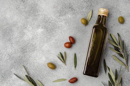 Glass bottle with olive oil on gray backgroundの写真素材