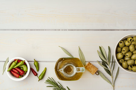 Olives and bottle of olive oil on wooden backgroundの写真素材
