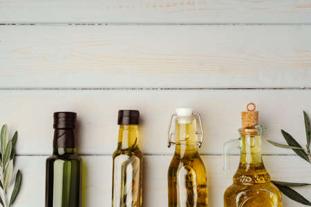 Glass bottle with olive oil on gray backgroundの写真素材