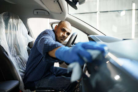 A man cleaning car interior, car detailing in Carwash serviceの写真素材