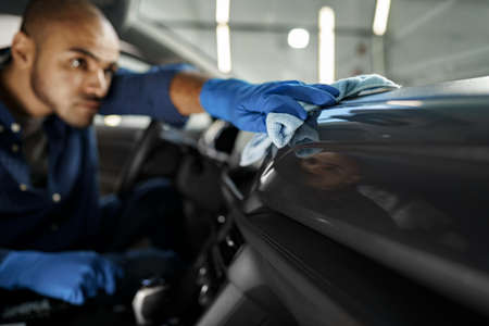 A man cleaning car interior, car detailing in Carwash serviceの写真素材