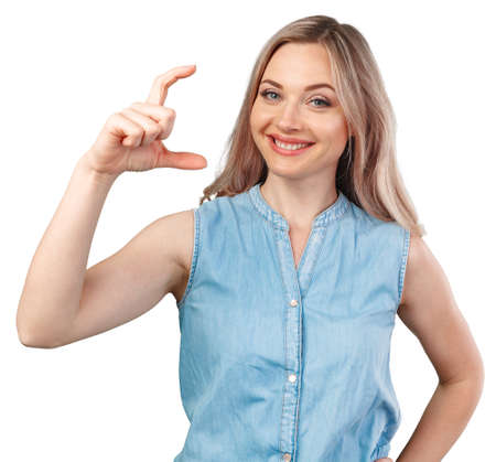 Happy smiling beautiful young woman showing the small size isolated on white
