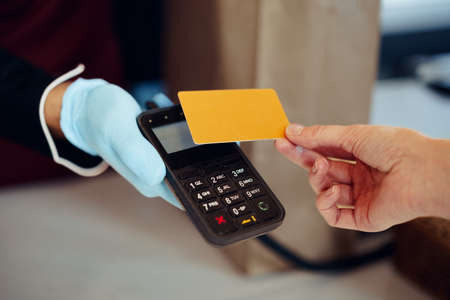 Close up of paying credit card for purchases process.