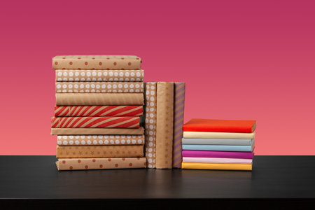 Stack of books on black wooden tableの写真素材