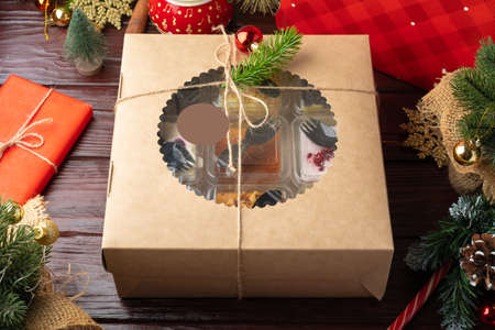 Set of different cakes in a craft box on brown wooden backgroundの写真素材