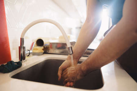 Chef washing his hands in a restaurant kitchen sinkの写真素材