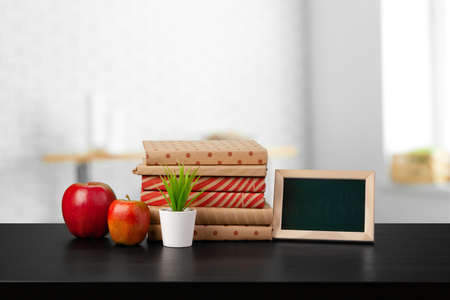 Stack of books on wooden table against blurred background
