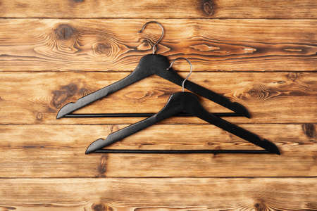 Composition with clothes hangers on wooden background.の写真素材