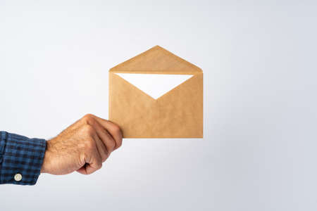 Male hands holding an envelope with a wax sealの写真素材