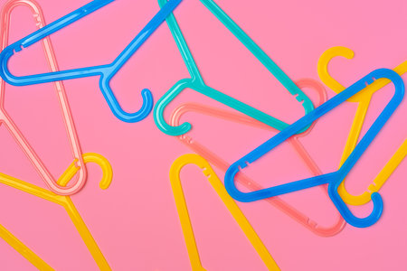 Flat lay composition with empty hangers on pink backgroundの写真素材
