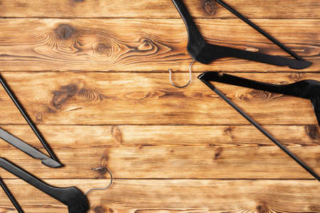 Composition with clothes hangers on wooden background.の写真素材