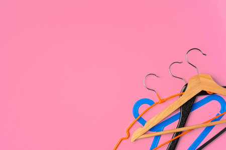 Flat lay composition with empty hangers on pink backgroundの写真素材