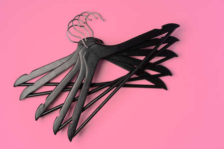 Flat lay composition with empty hangers on pink background