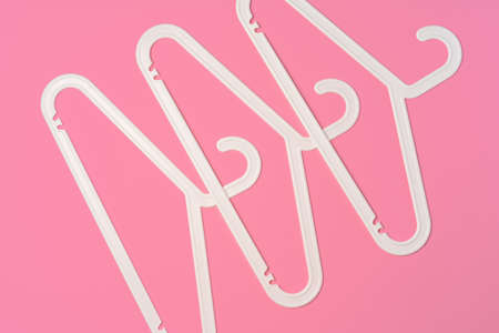 Flat lay composition with empty hangers on pink backgroundの写真素材