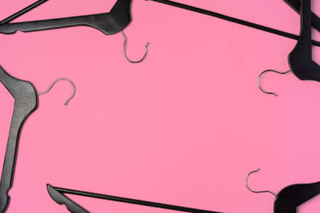 Flat lay composition with empty hangers on pink background