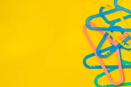 Hanger on colored paper background. Minimalistic fashion concept.の写真素材