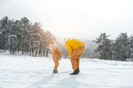 Father and son playing in the park on winter dayの写真素材