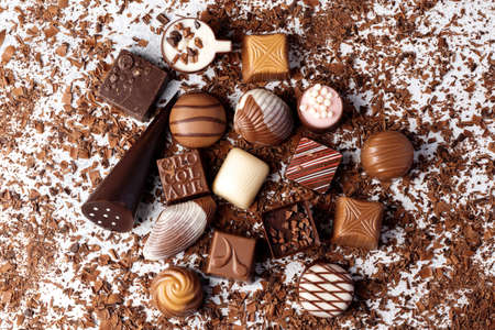 Chocolate candies and chocolate pieces pile for backgroundの写真素材