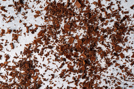 Grated dark chocolate shavings on gray backgroundの写真素材