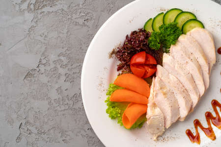 Roast chicken fillets and vegetables on gray backgroundの写真素材