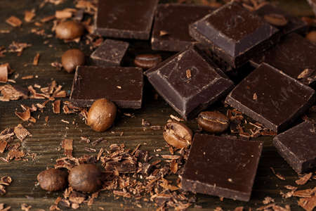 Roasted coffee beans with black chocolate close upの写真素材