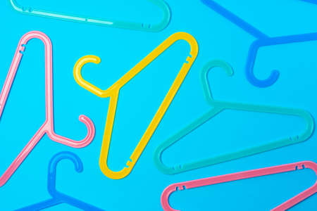 Blue hanger on trendy blue color background. Template fashion blog social media.
