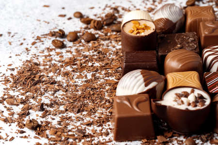 Chocolate candies and chocolate pieces pile for backgroundの写真素材