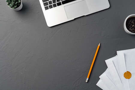 Mail envelope, coffee, pen and laptop on the desk.の写真素材