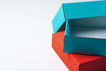 Pile of colorful cardboard boxes on white background