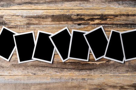 Blank photo frames for your photos on wooden background